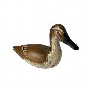 Vintage hand-carved wooden duck decoy with painted finish and glass eyes.